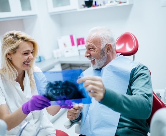 Senior man having dental treatment at dentist's office.